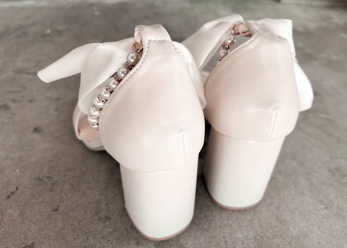 Trish Pearl Ankle Strap Bow Heels in Sand