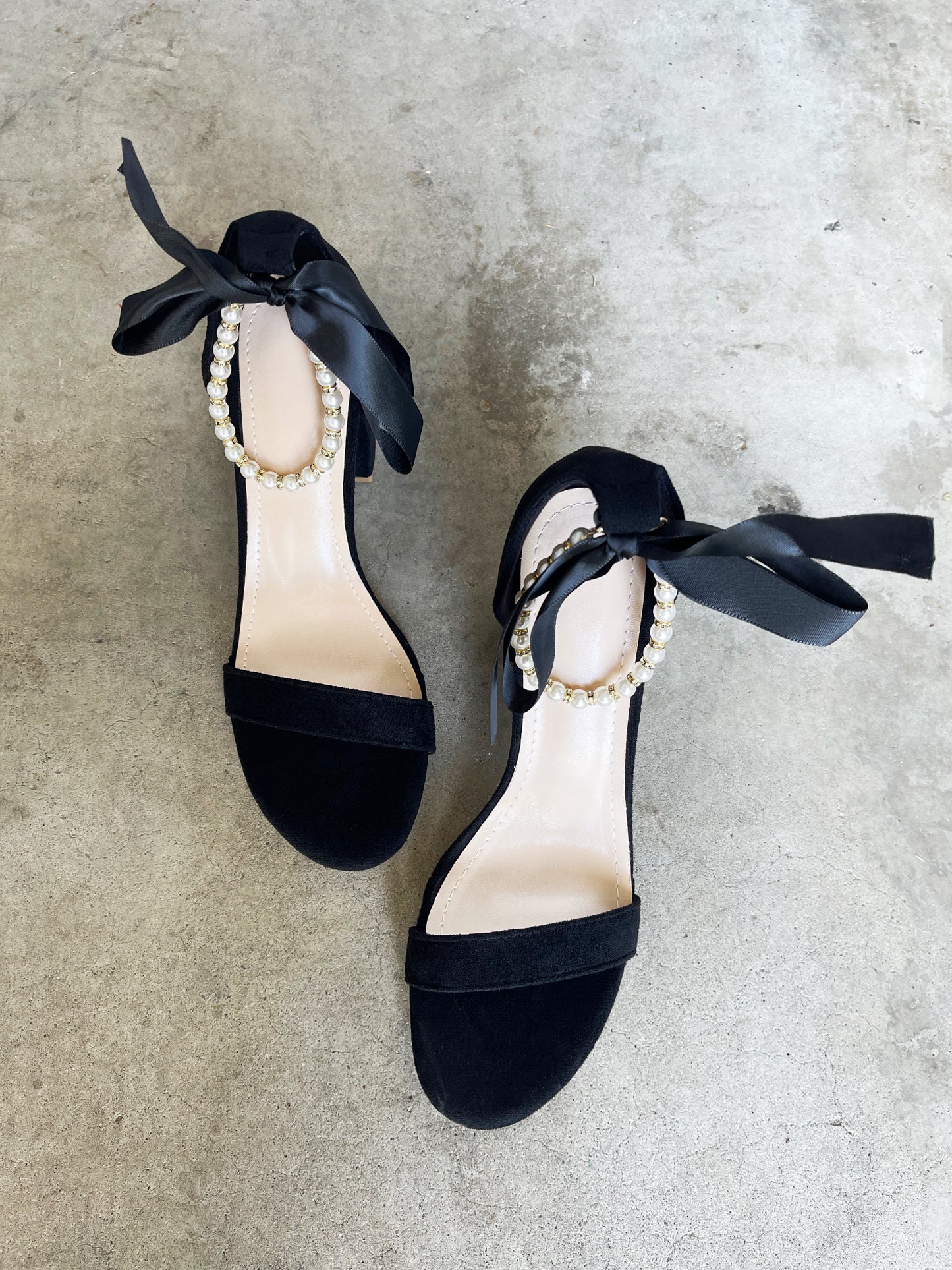Trish Pearl Ankle Strap Bow Faux Suede Heels in Black